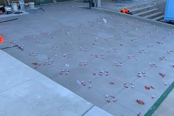 A Concrete Floor With a Lot of Tiles on It — ASpect Wall & Floor Tiling in Tuncurry, NSW