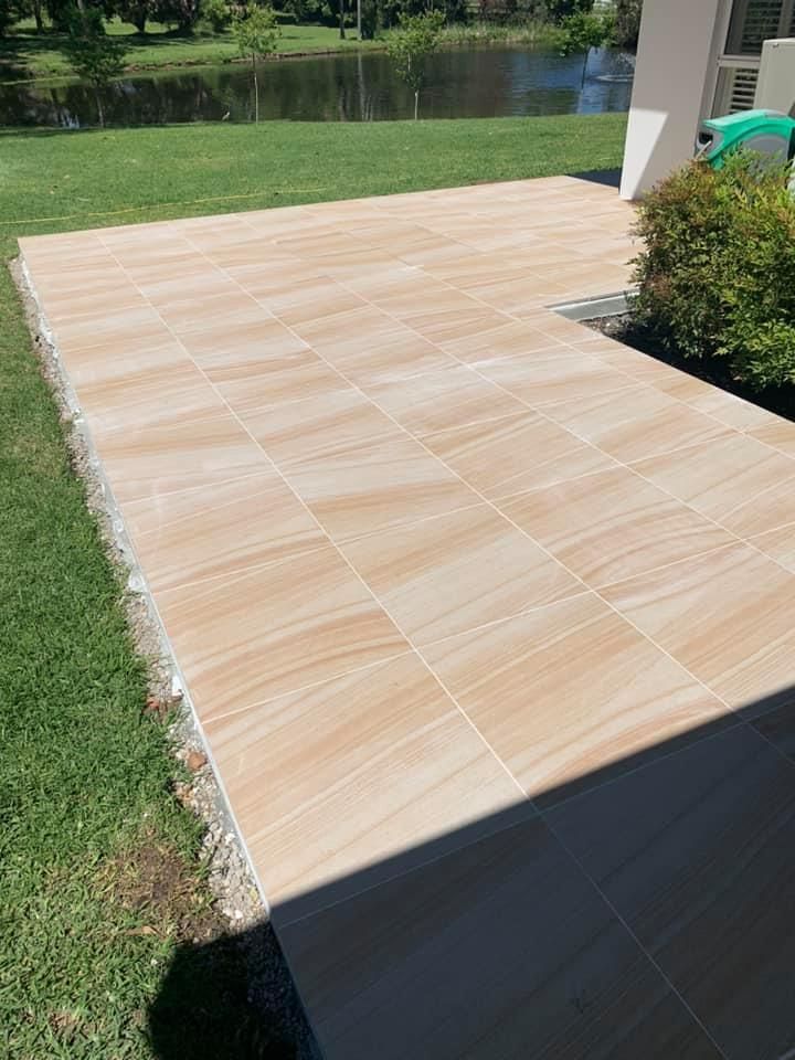 A Tiled Walkway Leading to a Pond in a Park — ASpect Wall & Floor Tiling in Newcastle, NSW
