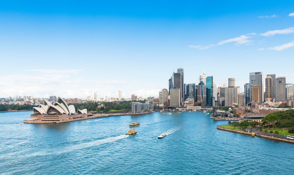 A Large Body of Water With a City Skyline in the Background — ASpect Wall & Floor Tiling in Sydney, NSW