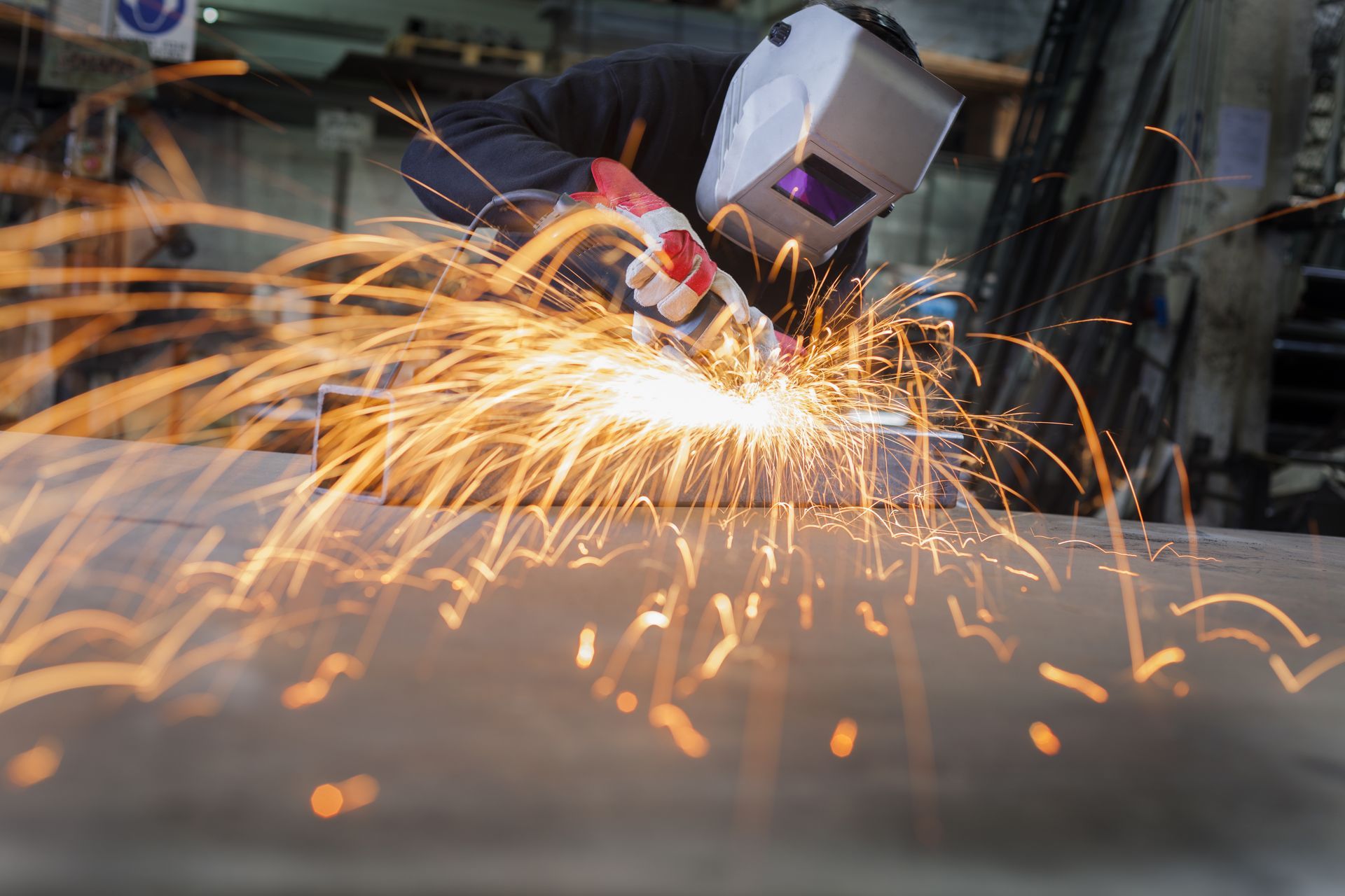 Welding a piece of metal in a factory