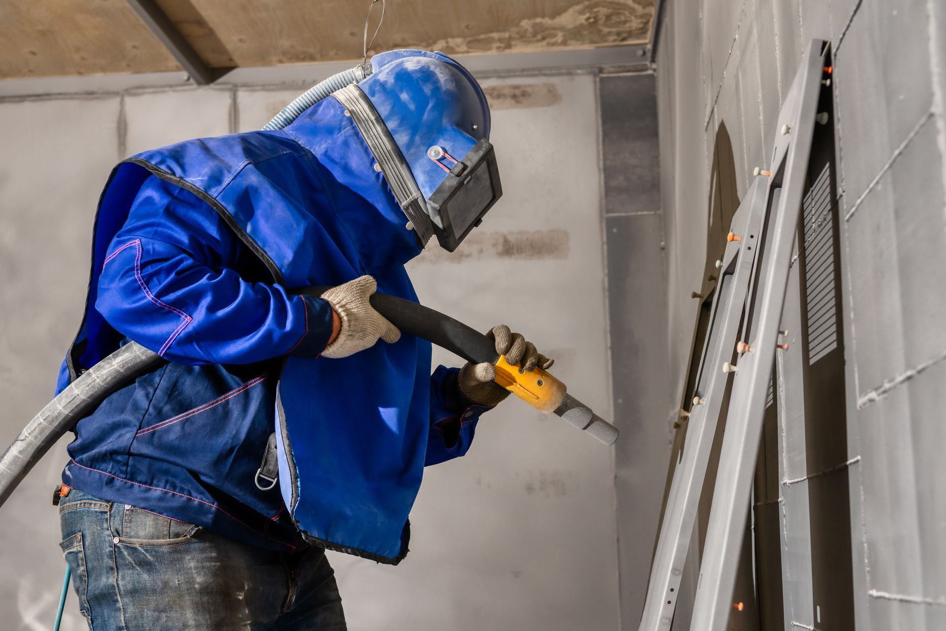Sand blasting the steel