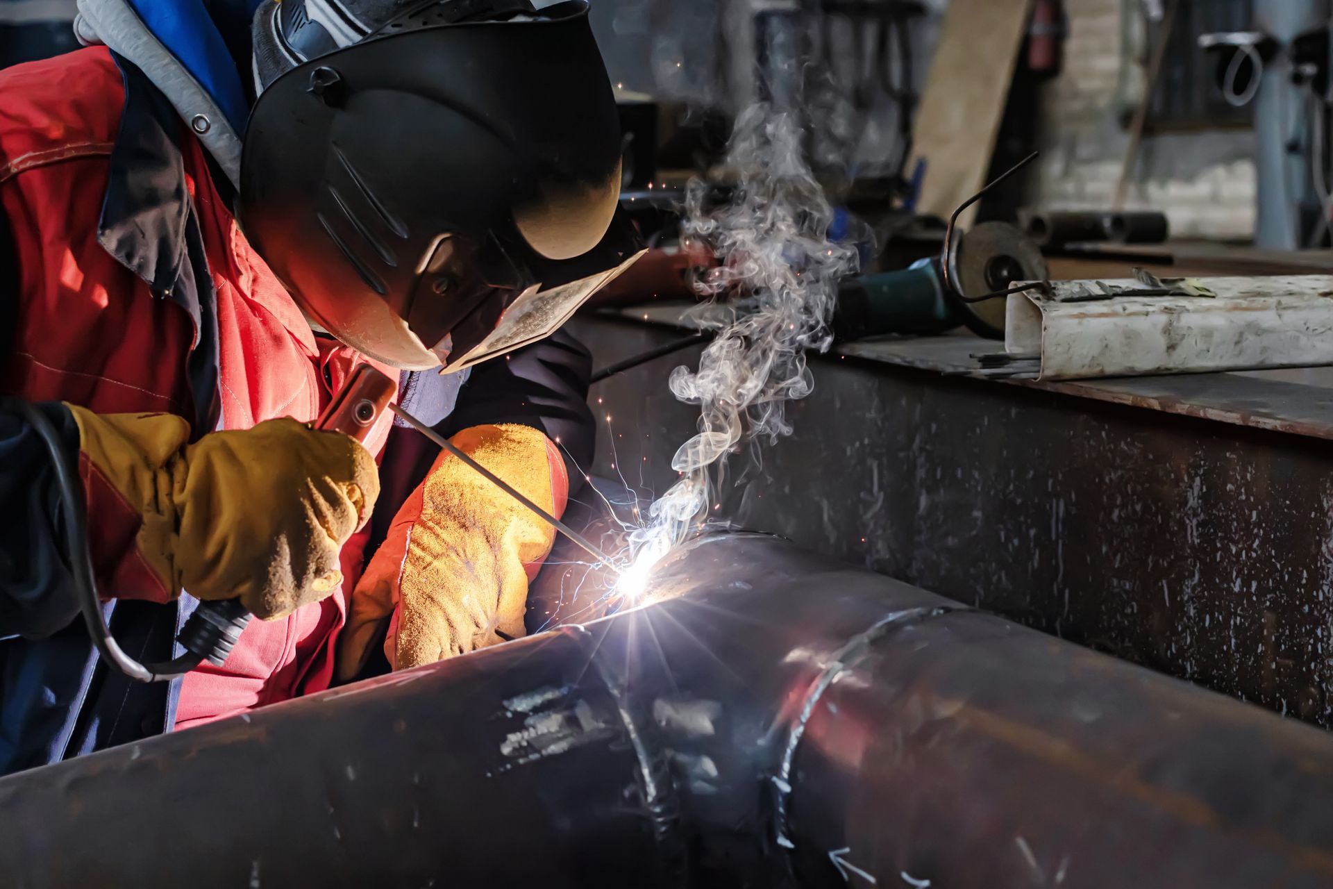 Welding a pipe in a factory