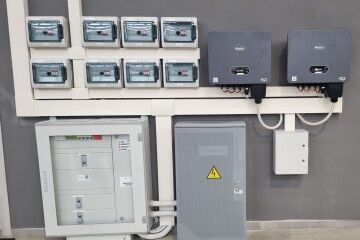 Contatore elettrico e scatole di controllo montati a parete su una parete del locale tecnico.