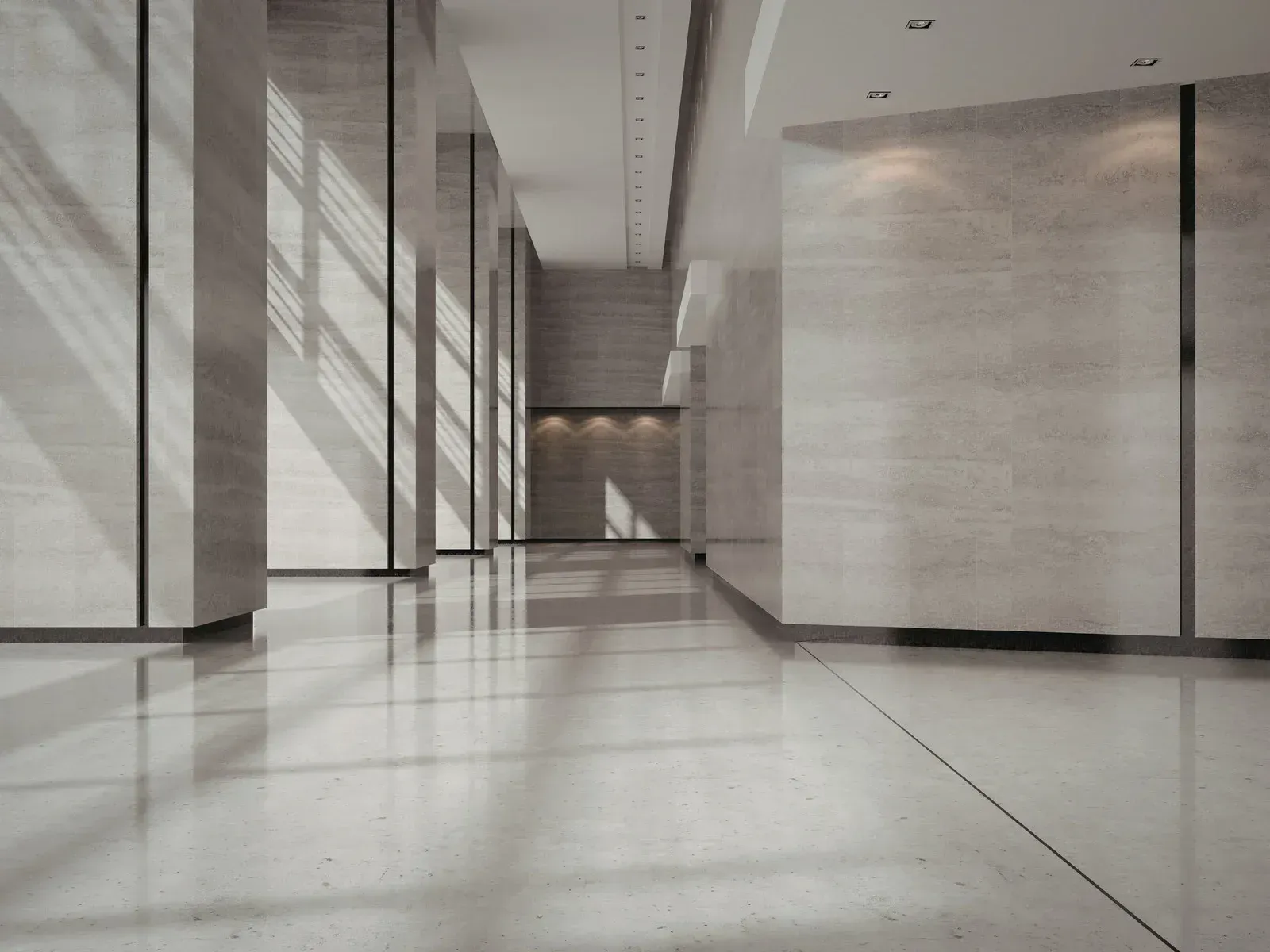 Empty modern hallway with tall columns, glossy marble floor, and soft daylight shadows