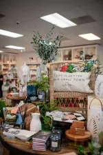 Display of home decor and gift items on a table in a bright store interior