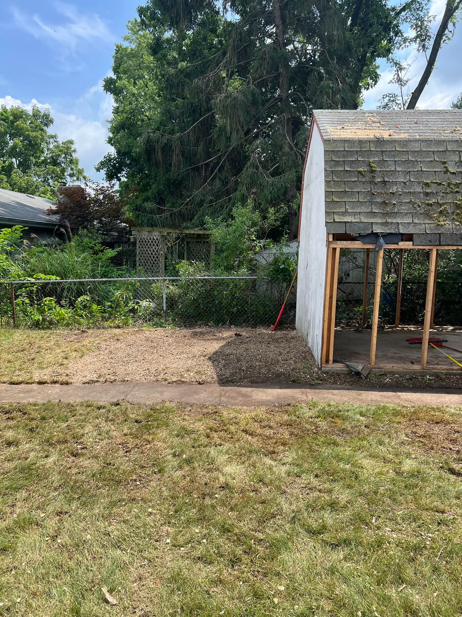 A shed is being built in the backyard of a house.