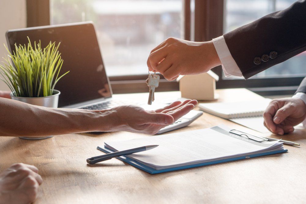 Person Receiving New House Keys — Loans in Warners Bay, NSW