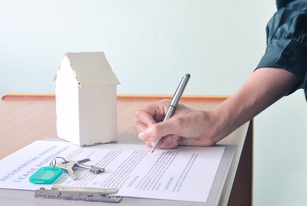 Hand Signing Residential Lease Agreement — Loans in Warners Bay, NSW