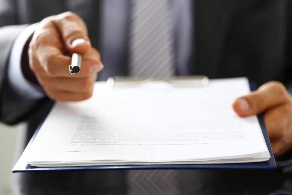 Agent Offering Pen To Sign Contract — Loans in Warners Bay, NSW