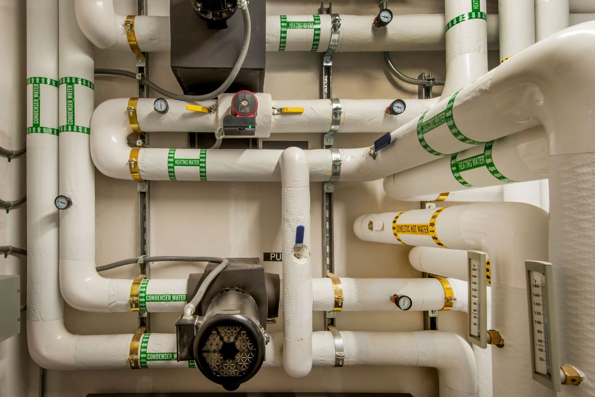 A bunch of white pipes are connected to each other in a room.