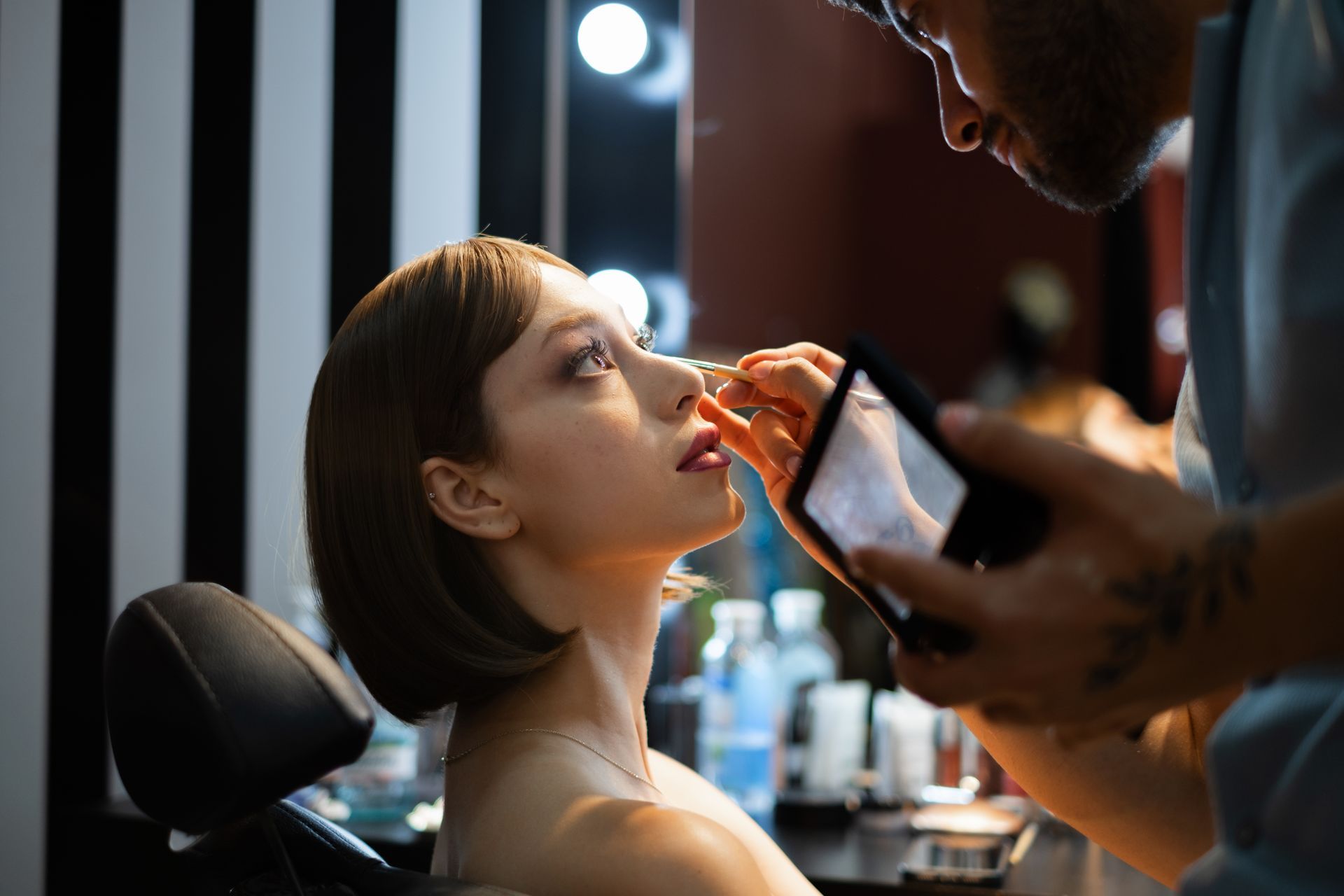 Customer receiving a makeup service, highlighting the expert services available at Luxe Cosmetic Studios.