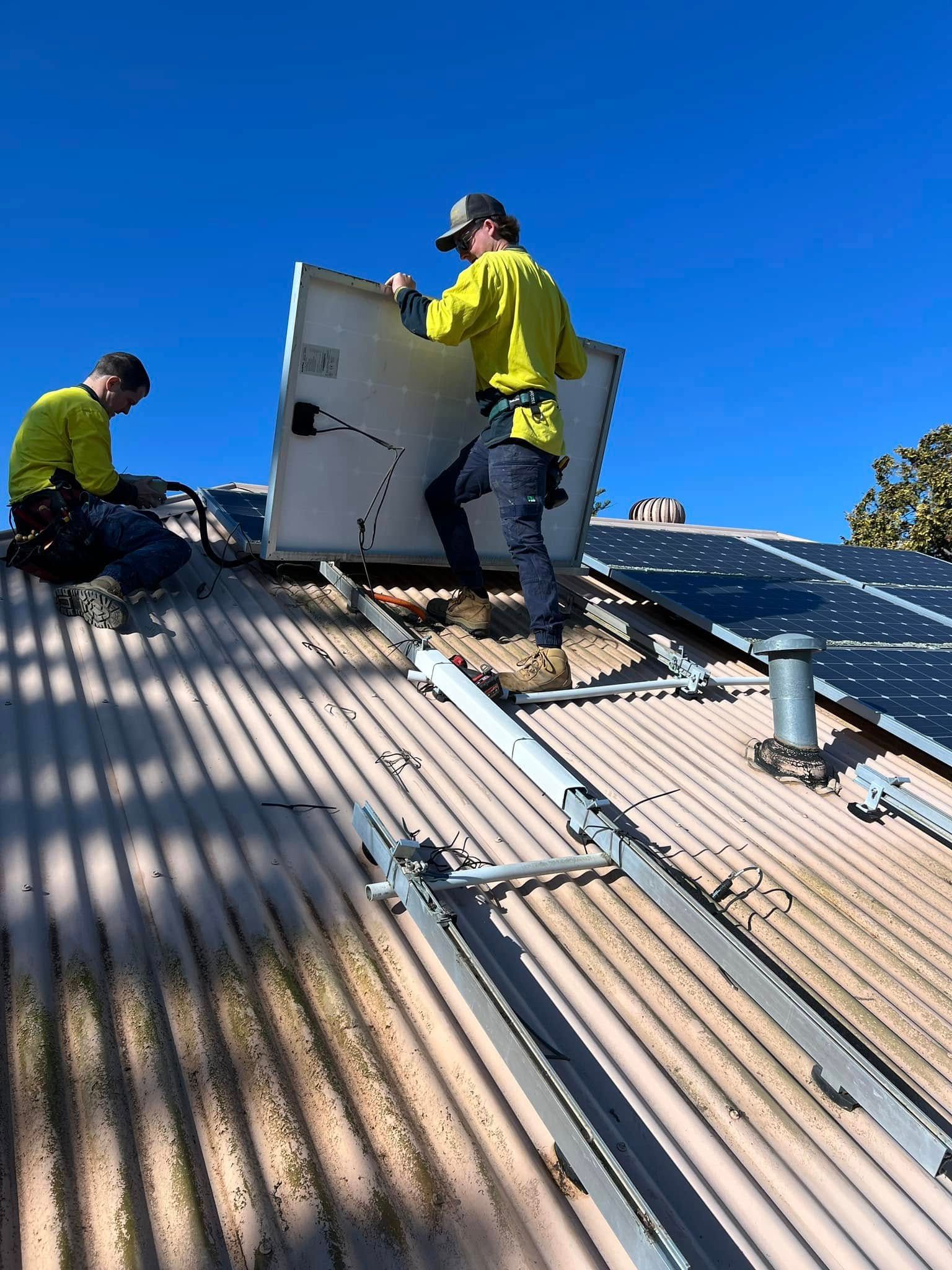 Worker Installing Solar Panel — Des Mullins Electrical & Solar in Wagga Wagga, NSW