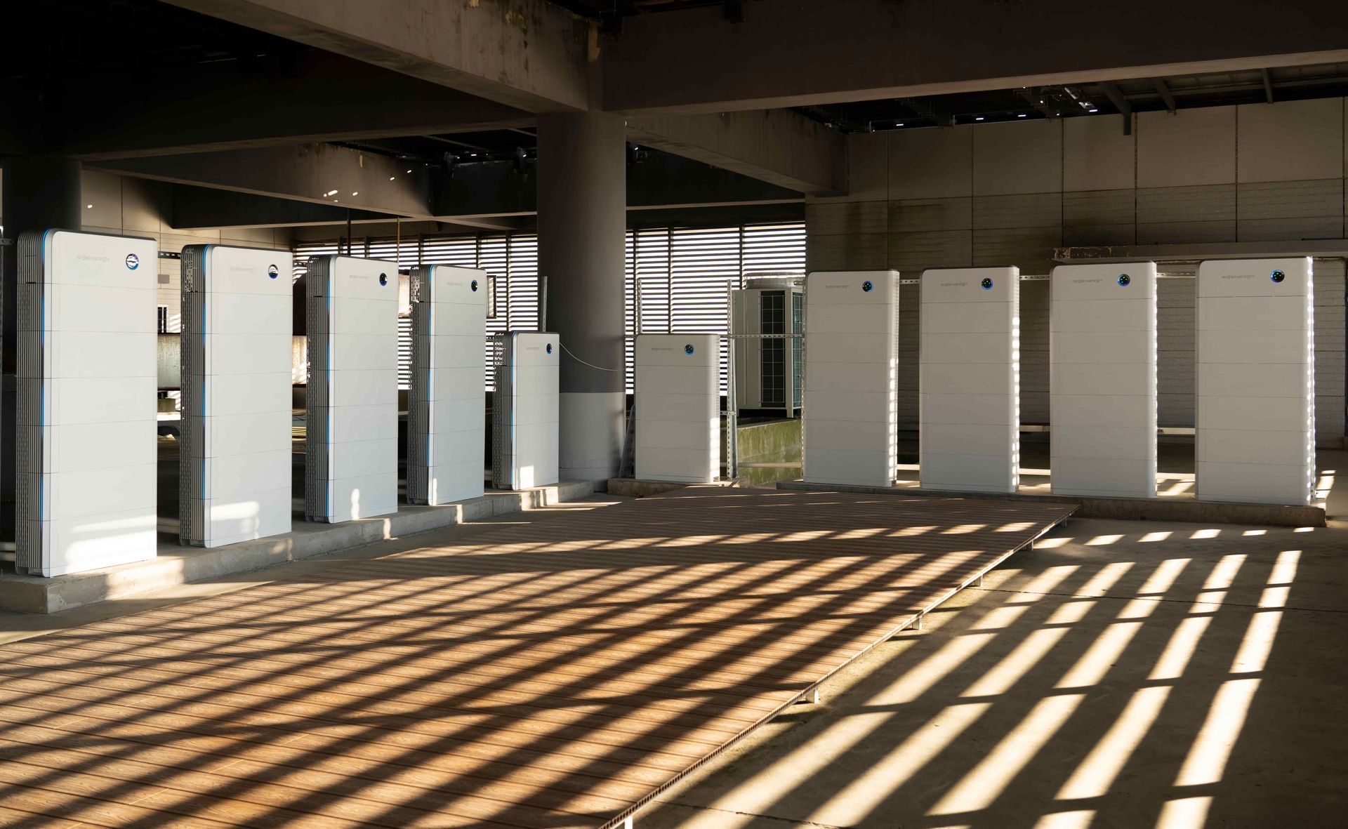 Row of White Electrical Panels Inside a Concrete — Des Mullins Electrical & Solar in Wagga Wagga, NSW
