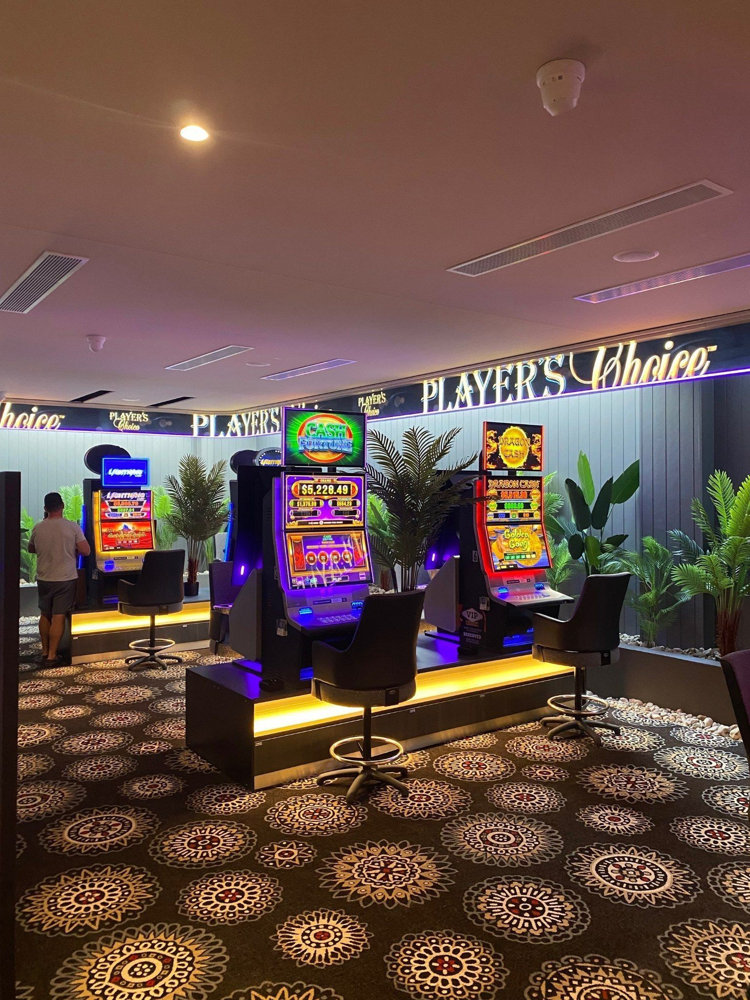 Casino Slot Machines With Bright Screens and Seating — Des Mullins Electrical & Solar in Wagga Wagga, NSW