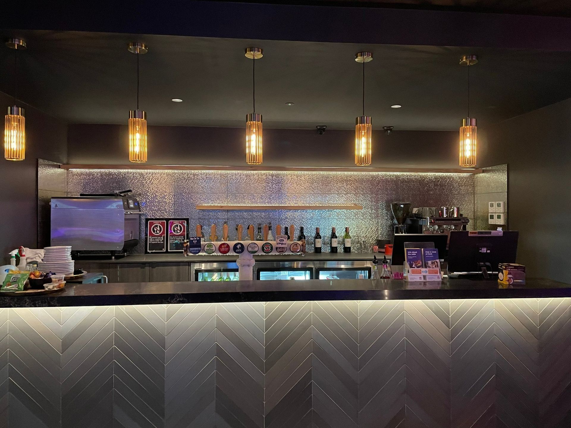 Bar With Golden Pendant Lights, Metallic Tiled Backsplash — Des Mullins Electrical & Solar in Wagga Wagga, NSW