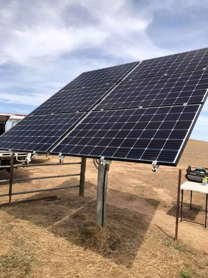 Solar Panels on a Metal Frame in a Field — Des Mullins Electrical & Solar in Wagga Wagga, NSW