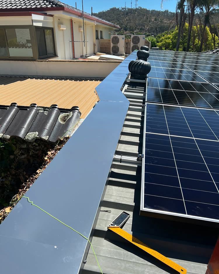 Solar Panels on a Roof With a Silver Metal Flashing — Des Mullins Electrical & Solar in Wagga Wagga, NSW