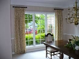 A Dining Room with A Table and Chairs and A Chandelier.