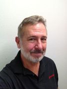 A man with a beard and mustache is wearing a black shirt