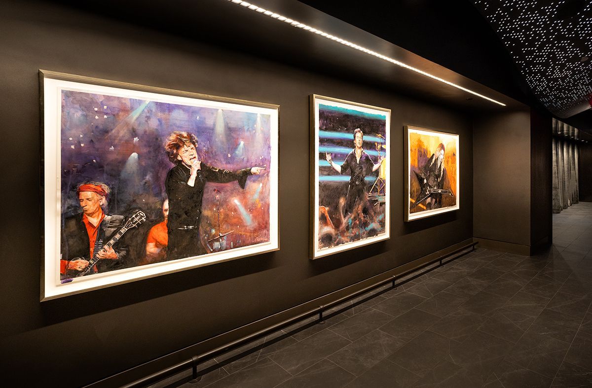 Large colorful mural and seating area in modern building lobby.