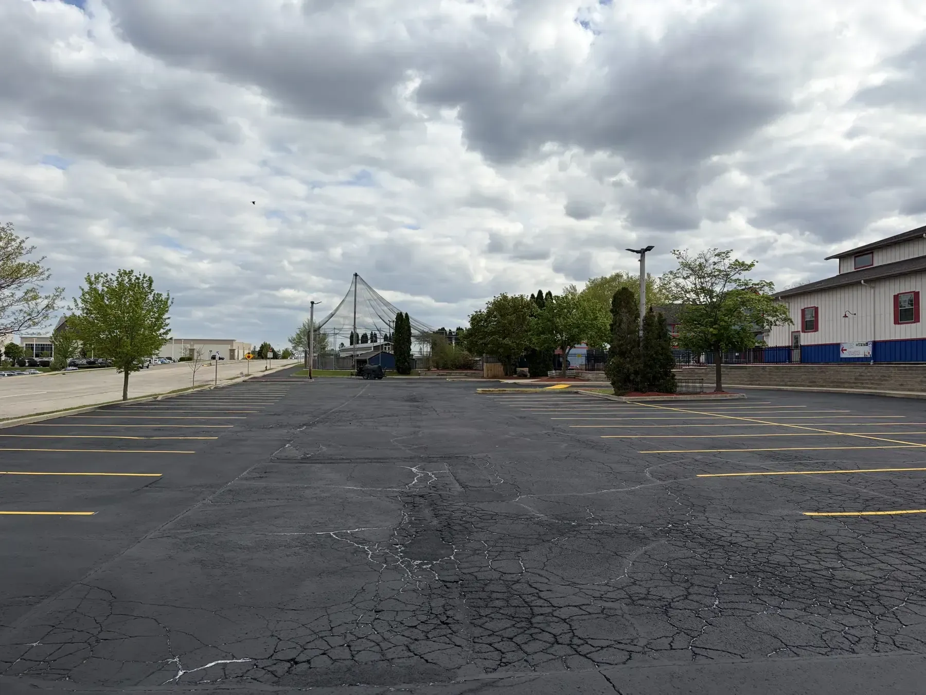 Purpose Contracting Asphalt sealcoating and parking lot striping project showing restored pavement and freshly painted traffic markings.