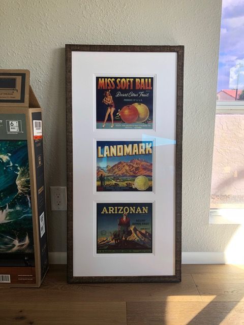 Framed poster trio on a wall: Miss Sitt Ball, Landmark, and Arizonan.