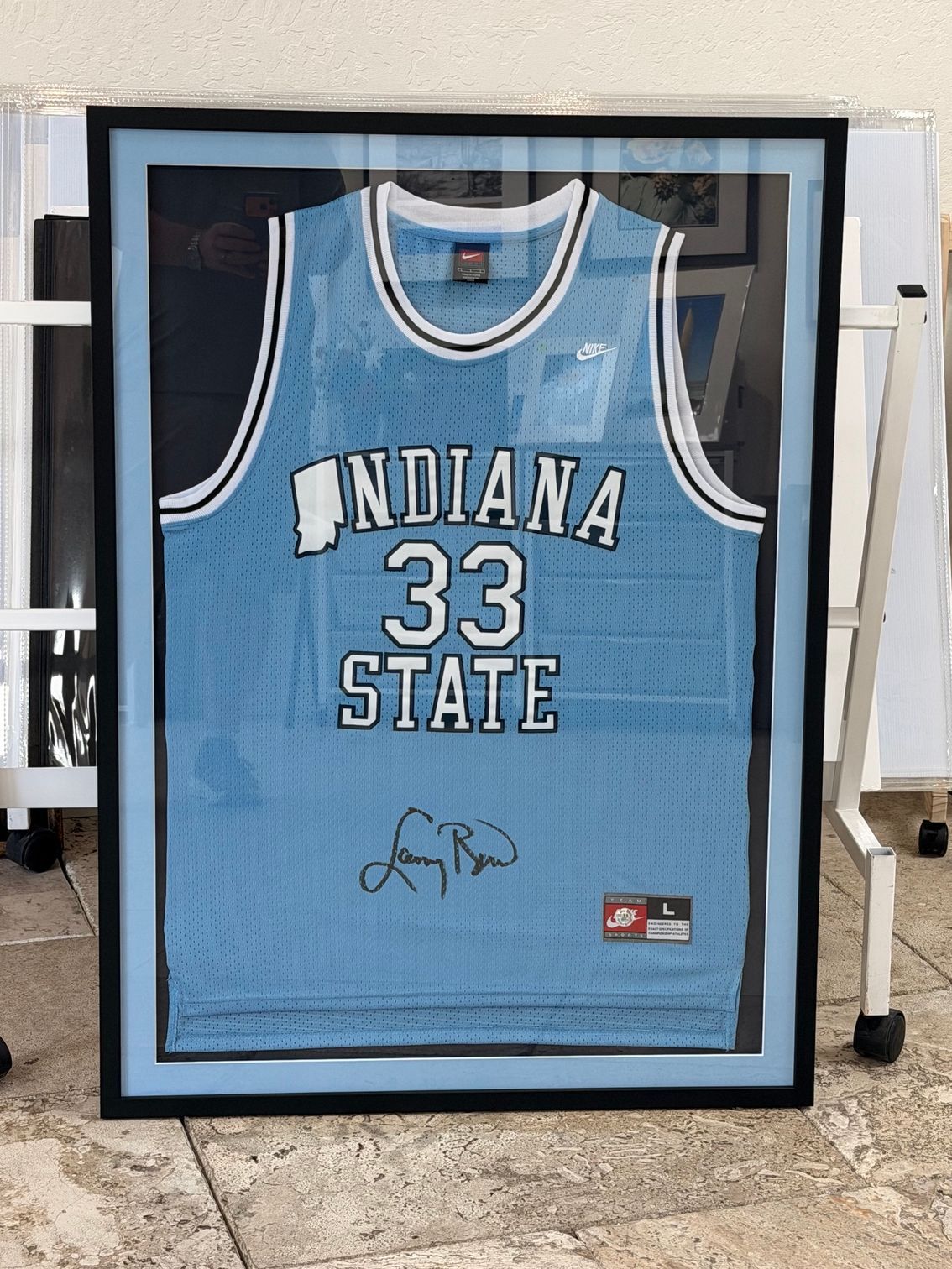 Framed light blue Indiana State basketball jersey with number 33 and autograph behind glass