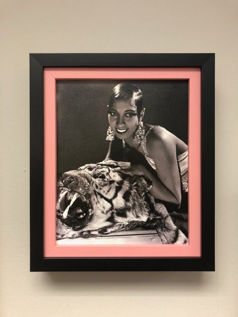 Framed black-and-pink vintage photo of a person posing beside a large fish sculpture