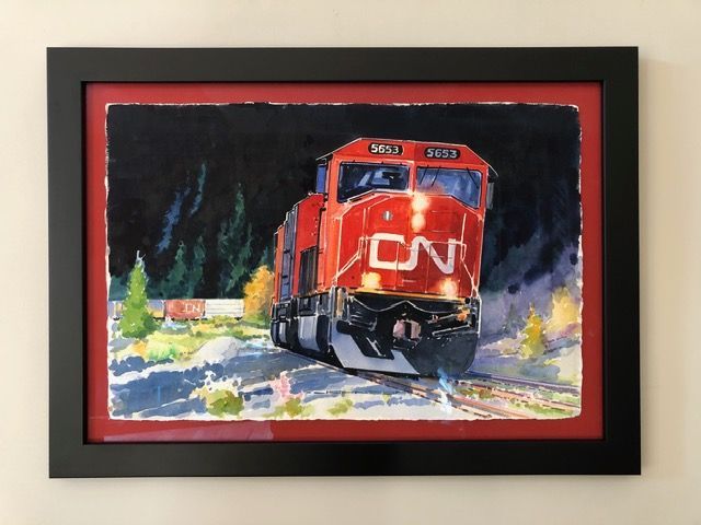 Framed painting of a red CN freight train rushing through a snowy scene