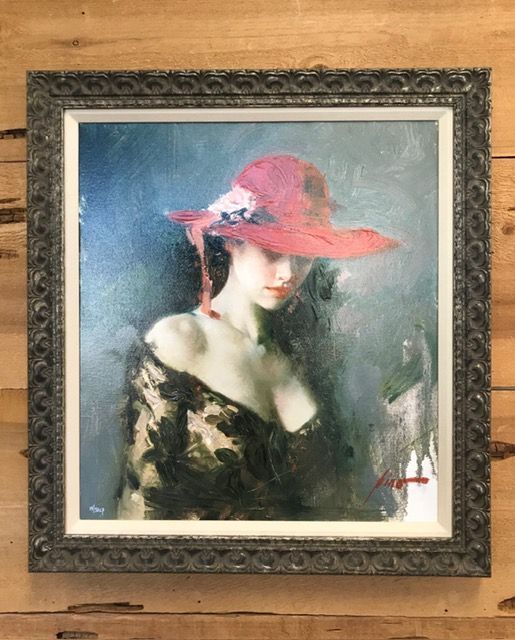 Framed portrait of a woman in a red hat and black dress against a blue background