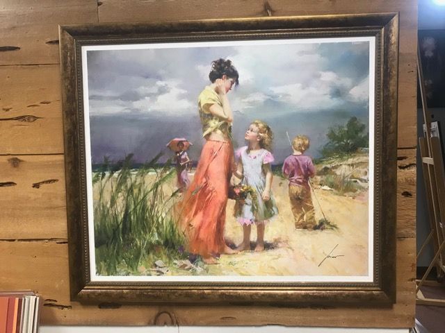 Framed watercolor of a woman and two children walking through a sandy landscape near the shore