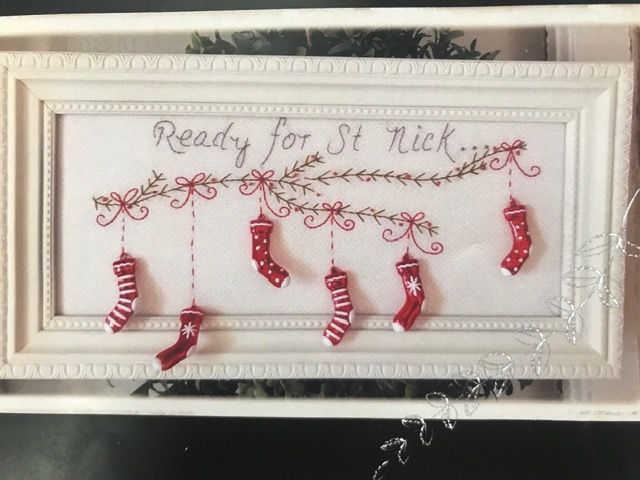 Framed “Ready for St. Nick” Christmas wall art with hanging red-and-white stockings