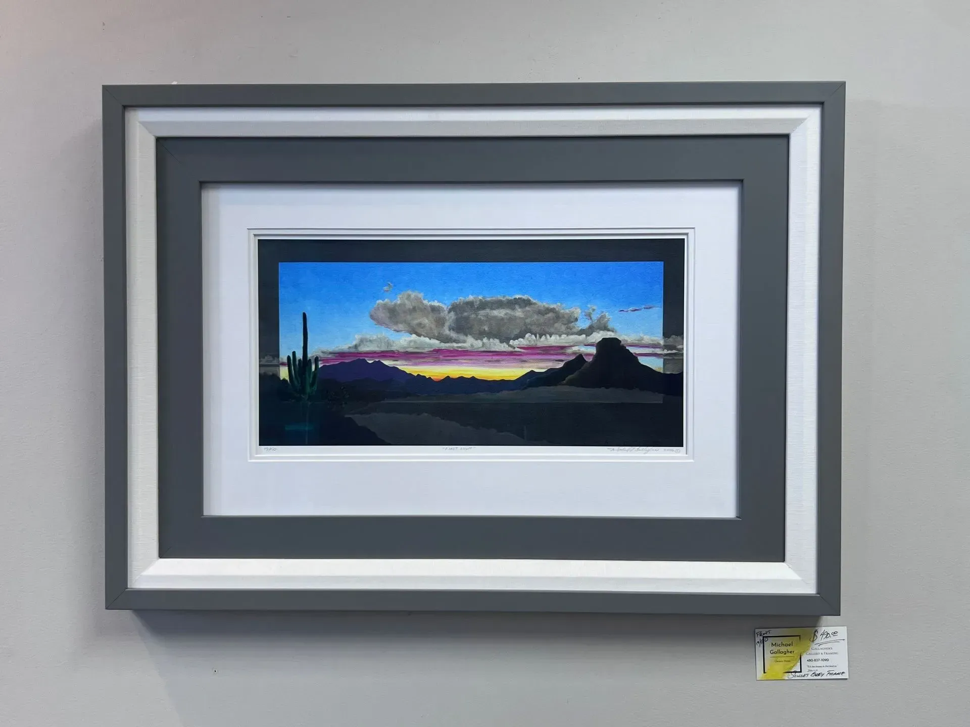 Framed abstract landscape with blue sky, purple horizon, and silhouetted trees in a gray mat frame
