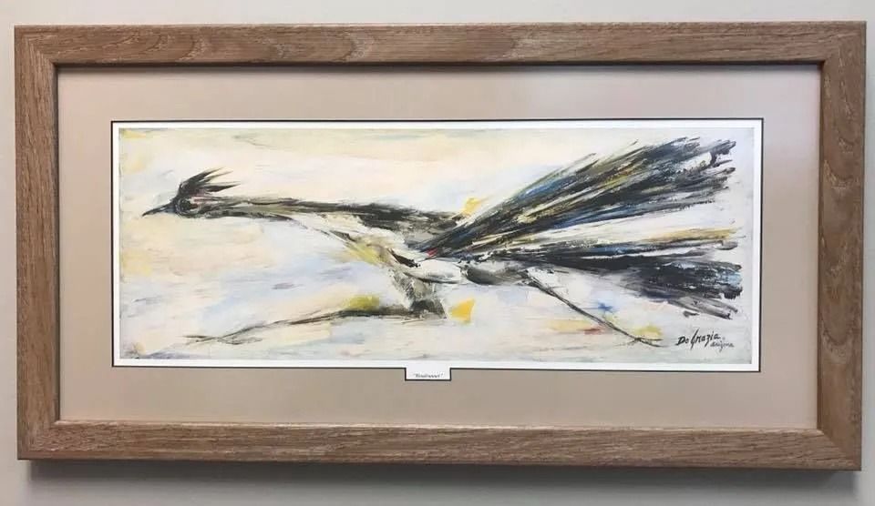 Abstract black-and-white painting with yellow accents, framed in a wooden frame.