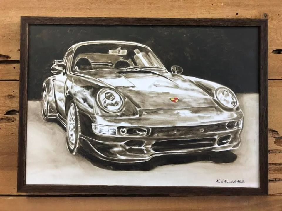 Framed sketch of a silver classic Porsche sports car on a wooden background.
