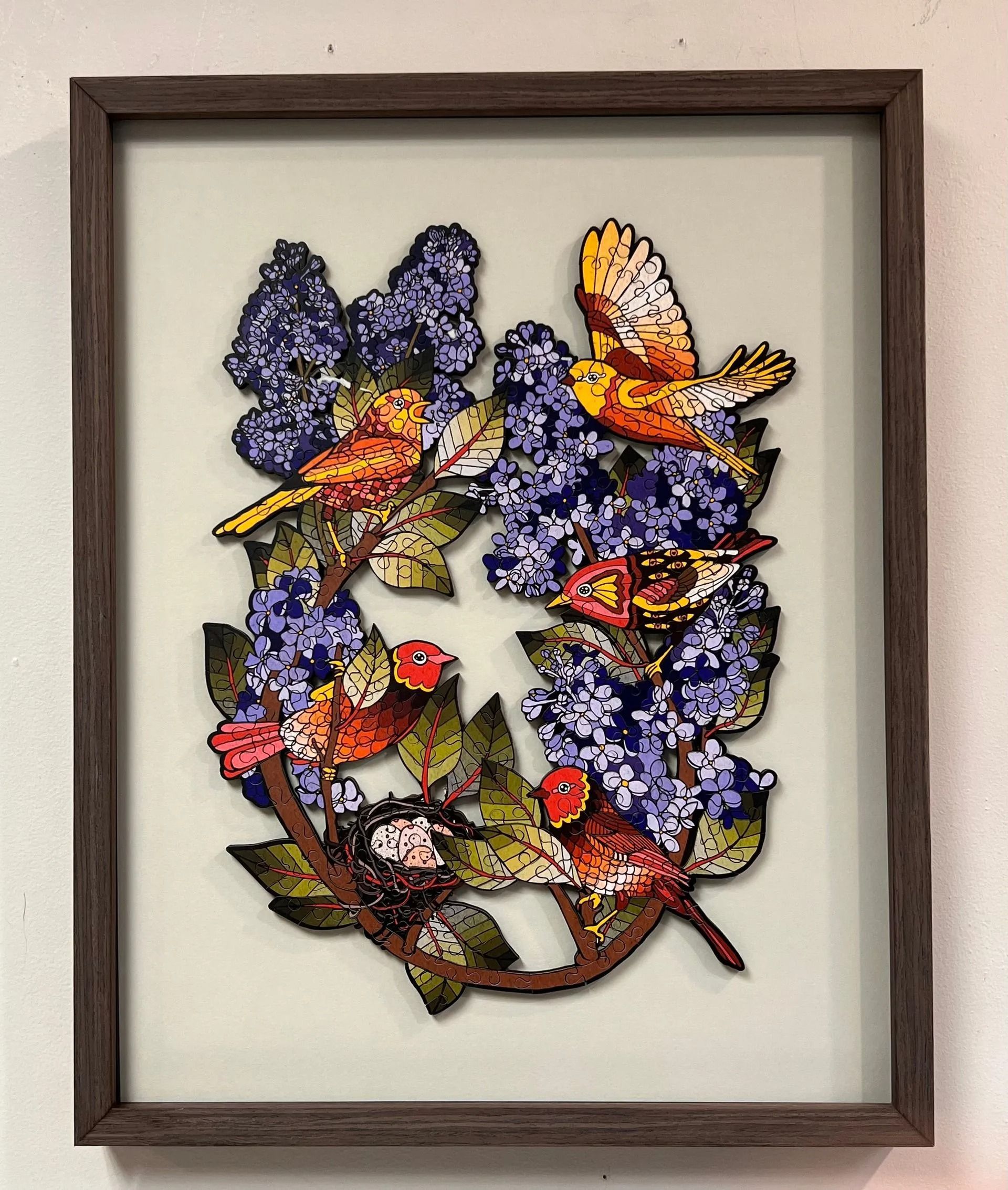 Framed floral butterfly artwork with purple blossoms and orange butterflies on a light background
