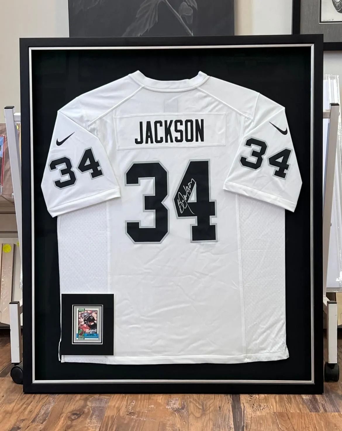 Framed white Jackson #34 football jersey with black numbers and nameplate