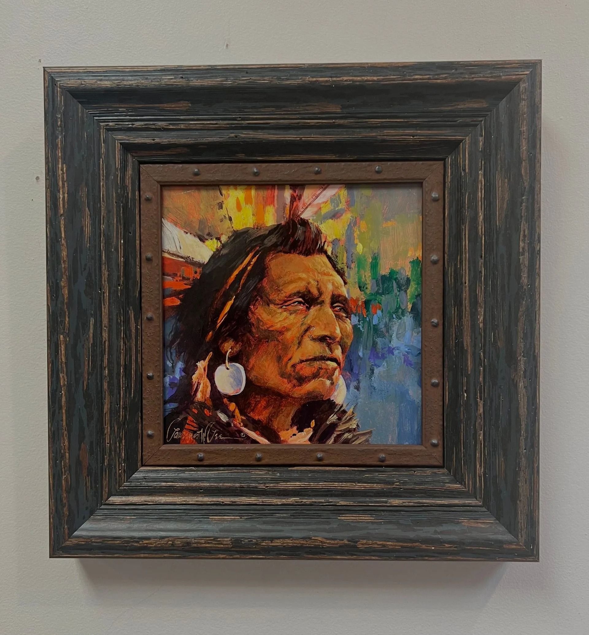 Framed painting of a Native American profile with a colorful abstract background