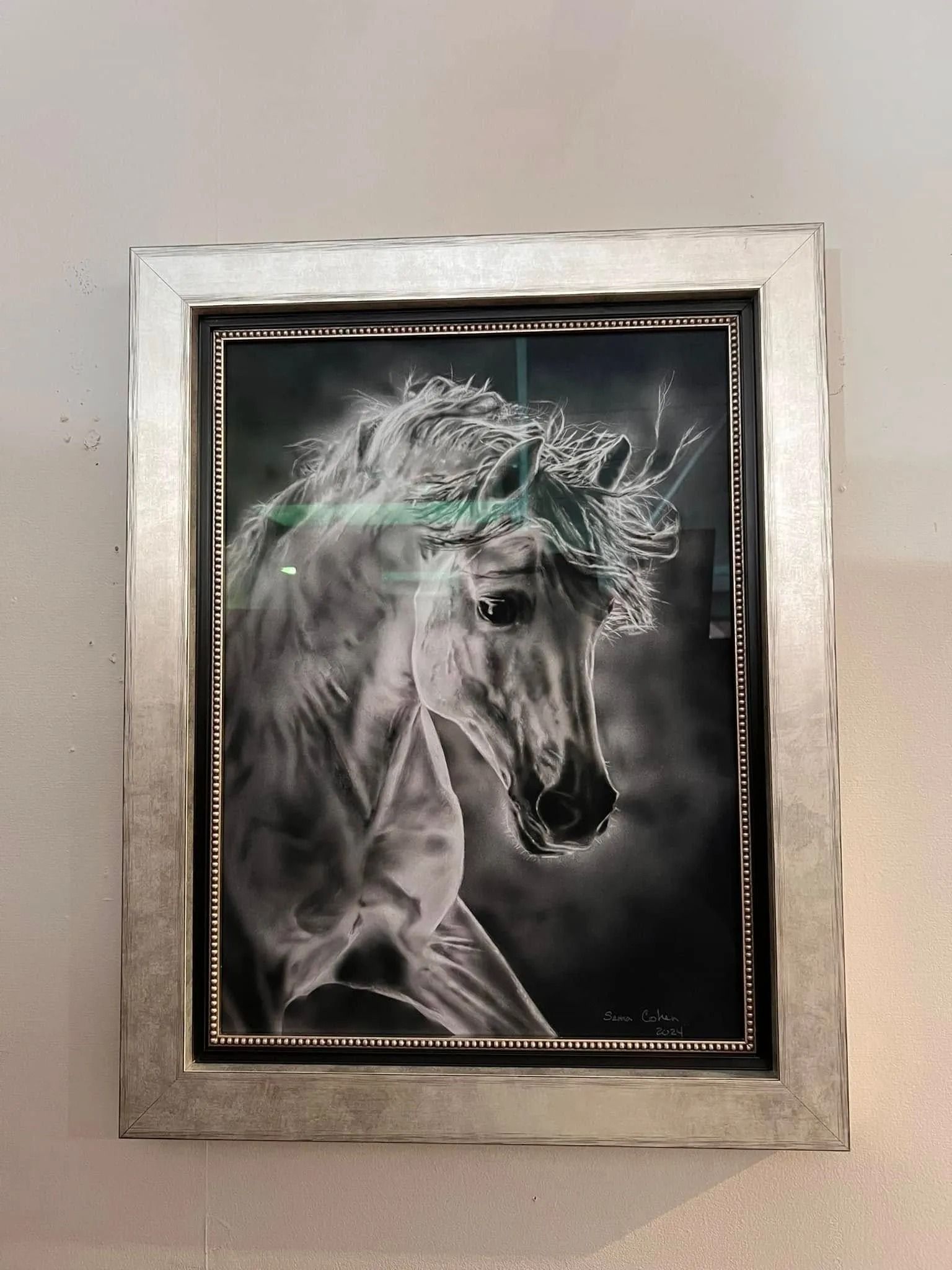 Framed black-and-white horse portrait with a silver frame and decorative dotted border