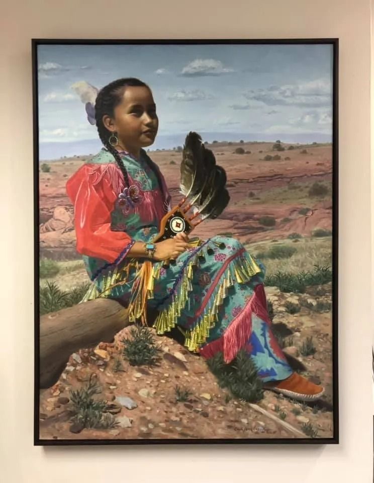 Portrait-style painting of a seated girl in colorful clothing holding a black feather fan in a desert landscape.