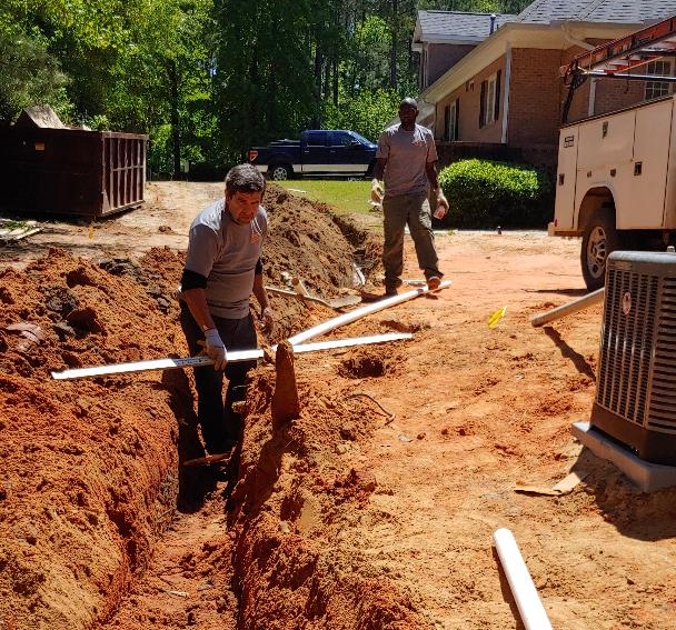 Two Workers with Pipes — Aiken, SC — Addie’s Septic Tank Two Workers with Pipes — Aiken, SC — Addie’s Septic Tank