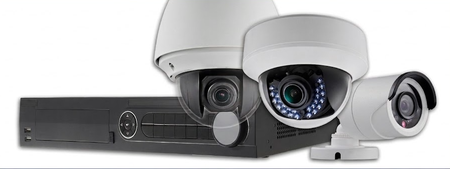 A group of security cameras are sitting next to each other on a white background.