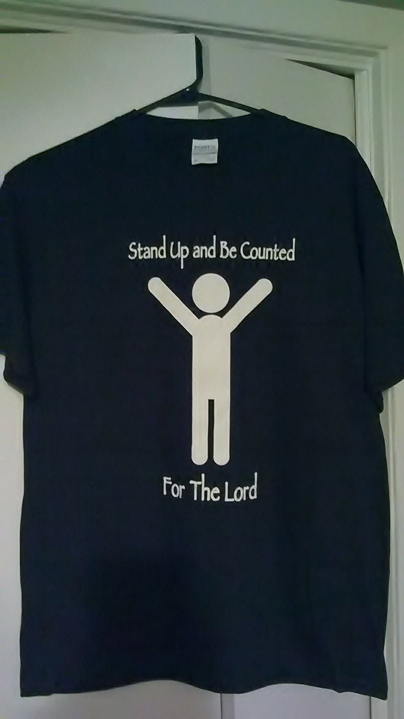 Black T-shirt with white figure and text: “Stand Up and Be Counted For The Lord.”