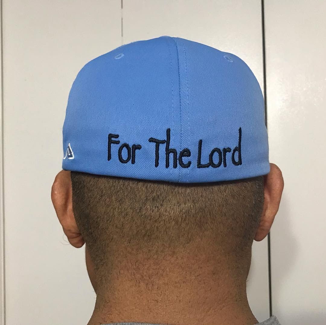 Back of a person wearing a blue cap with the words “For The Lord” embroidered on it