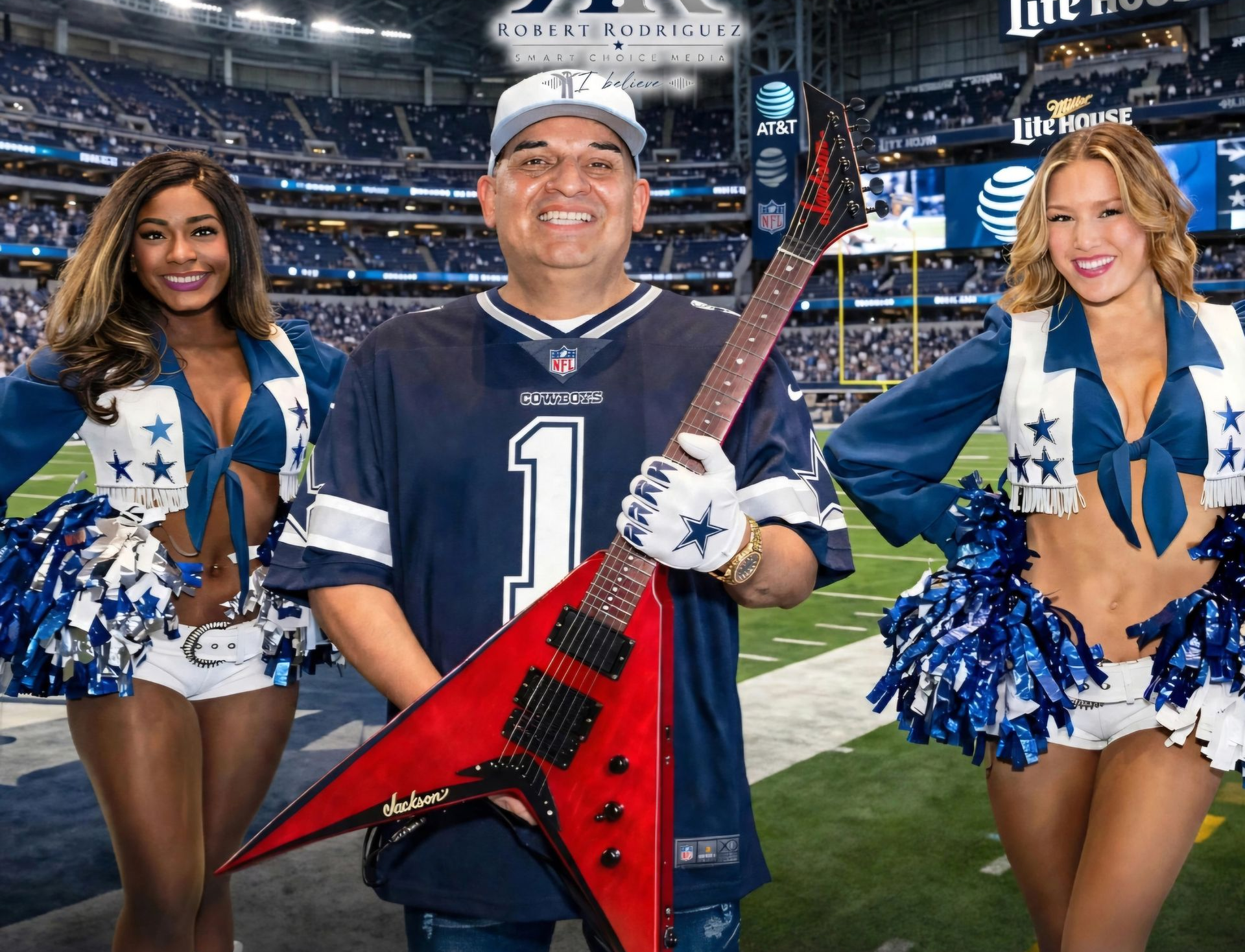 Three Dallas Cowboys cheerleaders flank a smiling man holding a red guitar on a football field
