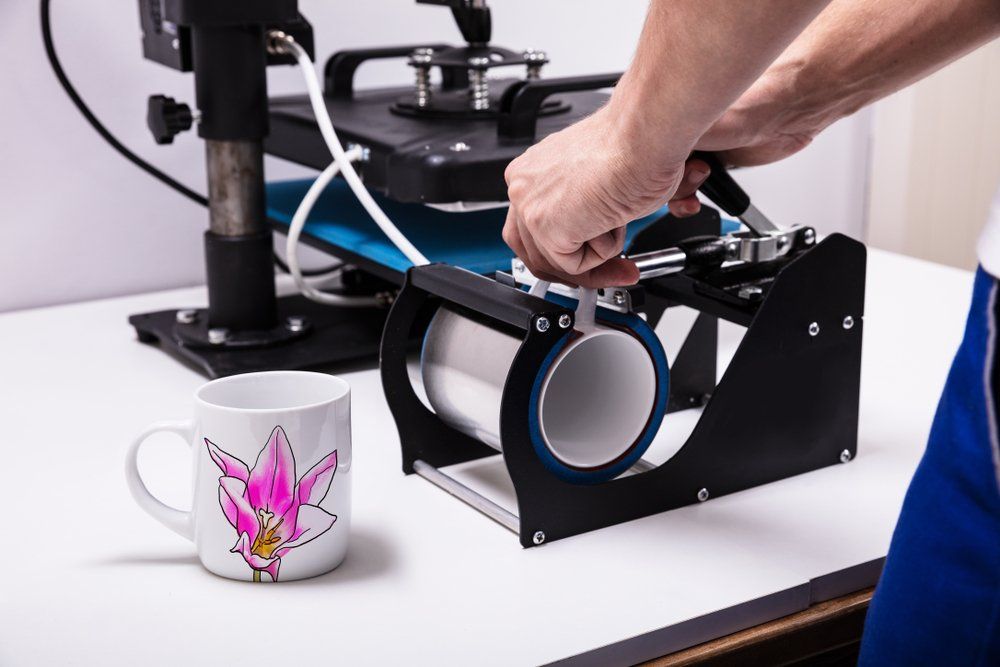 Man Printing On Coffee Mugs In Workshop — Screen Printing In Lismore, NSW