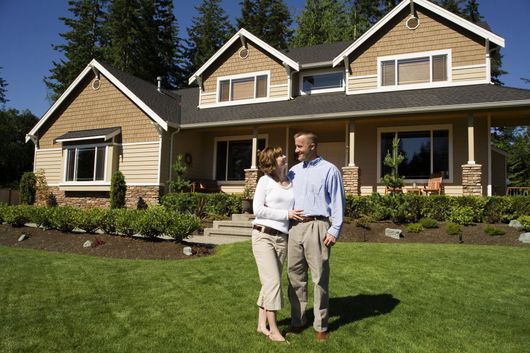 Married Couple In Front Of Their House - Greenwood, SC - Loggins Roofing, LLC