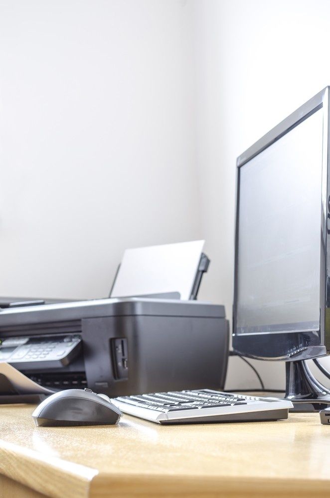 A Computer Monitor, Printer, and Mouse Sit on A Desk — Oz Data Tech in Taree, NSW