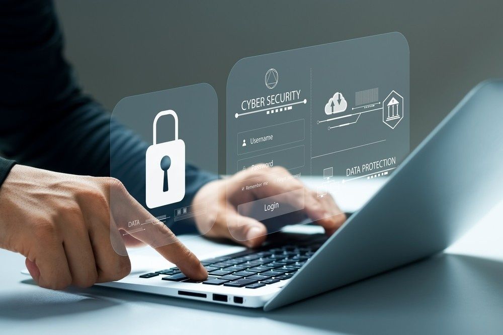 Person Working on A Laptop with Digital Cybersecurity Overlays — Oz Data Tech in Taree, NSW