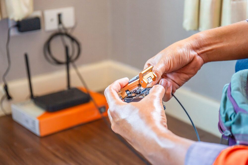 A Person Is Fixing A Router In A Living Room β Oz Data Tech in Forster, NSW